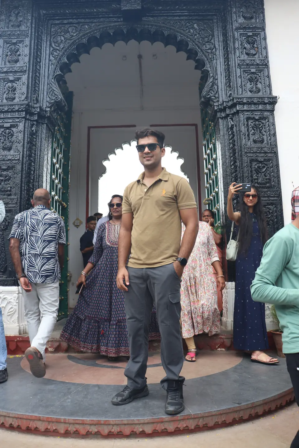 Pritish Bhatti in black sunglasses and a green t-shirt, shot from a low angle