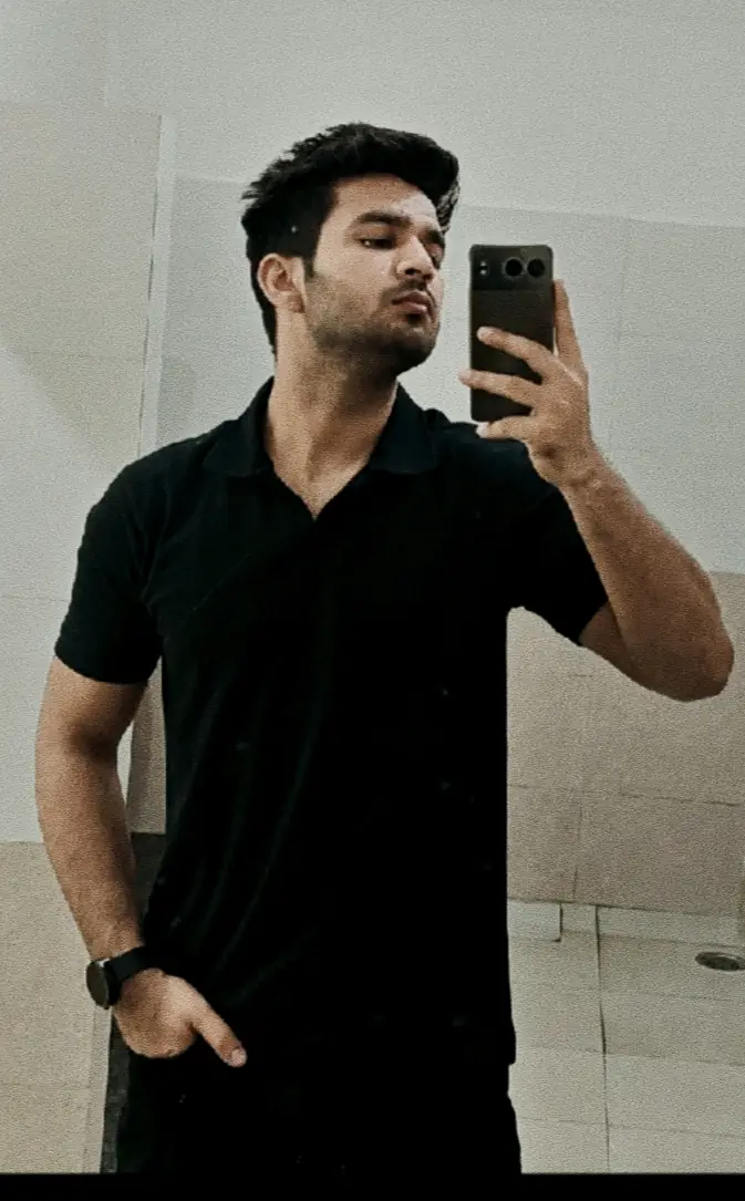 Pritish Bhatti mirror portrait in a black t-shirt